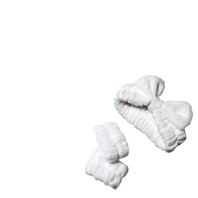 Soft white spa headband with bow and matching wristbands.