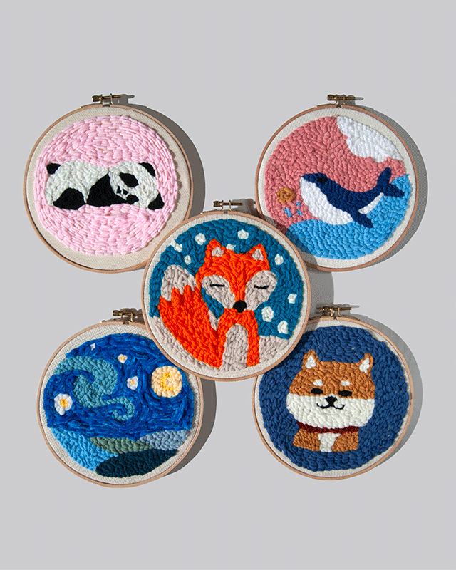 Set of five embroidered hoop art pieces four different animals, and the starry night, on a grey background