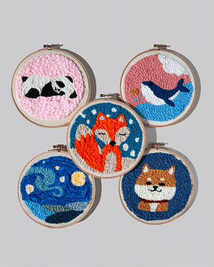 Set of five embroidered hoop art pieces four different animals, and the starry night, on a grey background