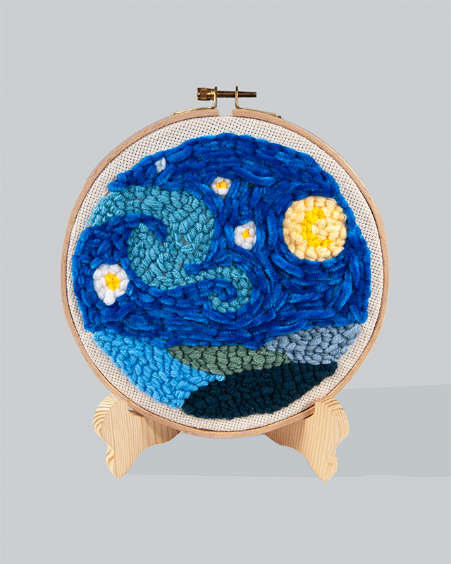 Embroidery hoop design inspired by Van Gogh’s Starry Night, featuring swirling blue patterns with yellow stars and moon.
