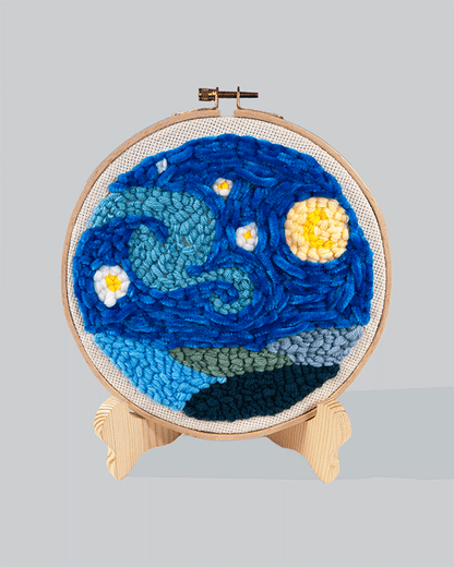 Embroidery hoop design inspired by Van Gogh’s Starry Night, featuring swirling blue patterns with yellow stars and moon.