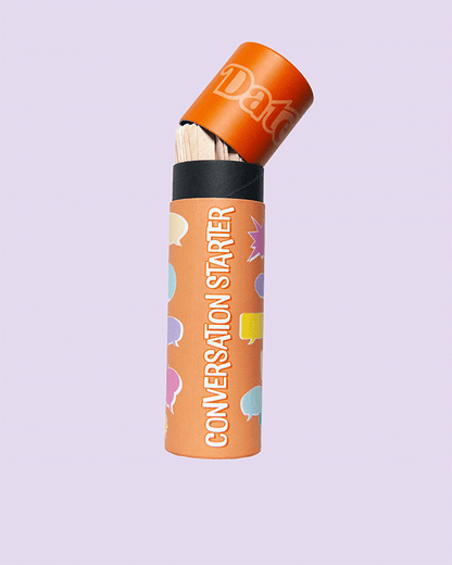 Conversation Starter game tube standing upright with orange lid slightly open, revealing wooden sticks inside, on a light purple background.